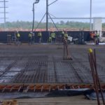 Construction workers are working on setting up a worksite and shotcrete for the construction of Woolworths' Moorebank distribution centers.